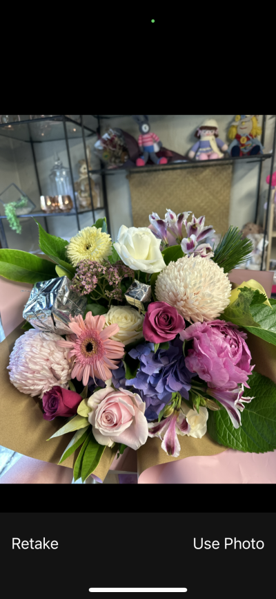 Pretty Christmas - A lovely assortment of flowers made into a bouquet with Christmas ornaments to compliment